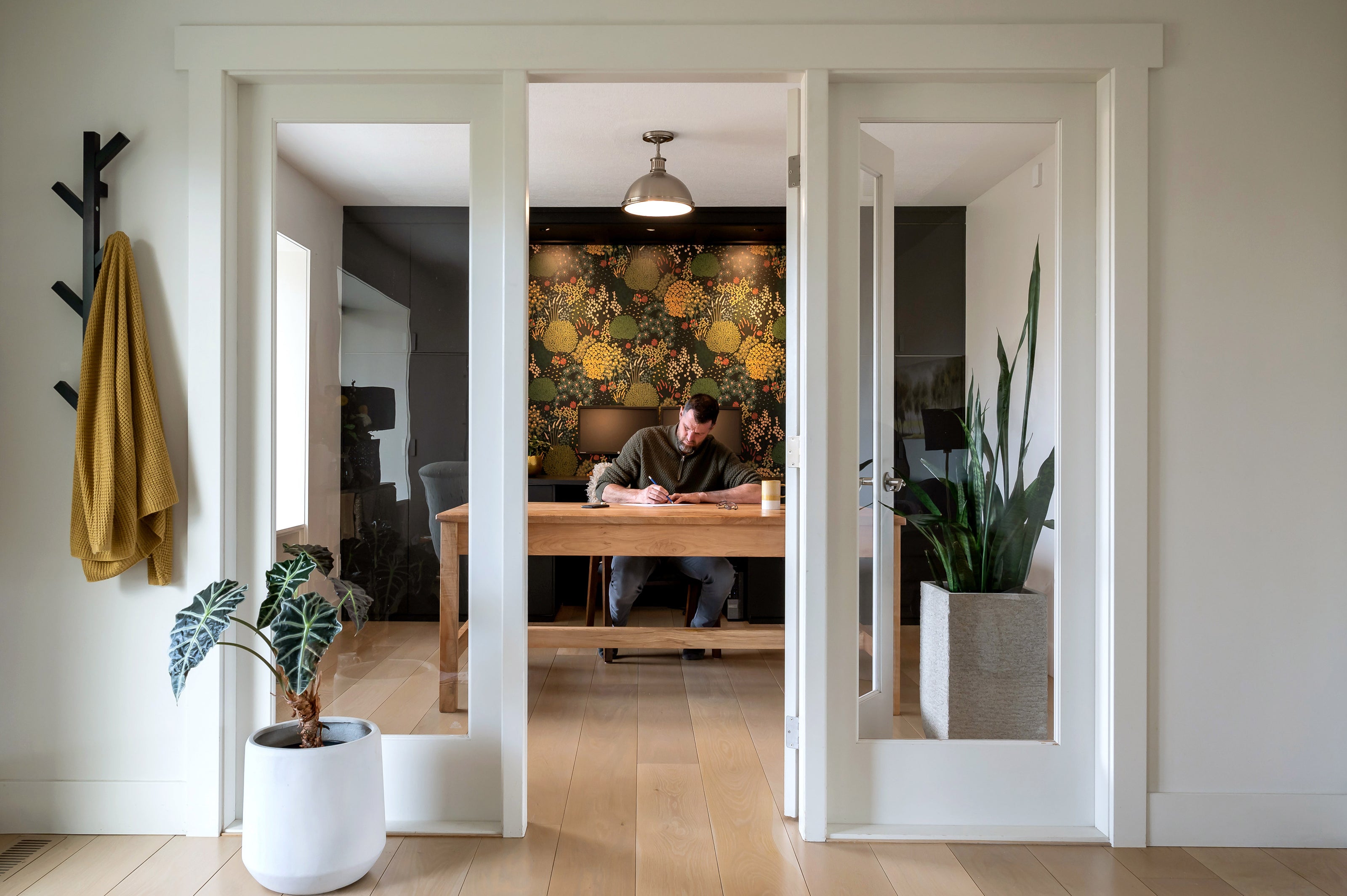 View of Jack working on a landscape design in his office.