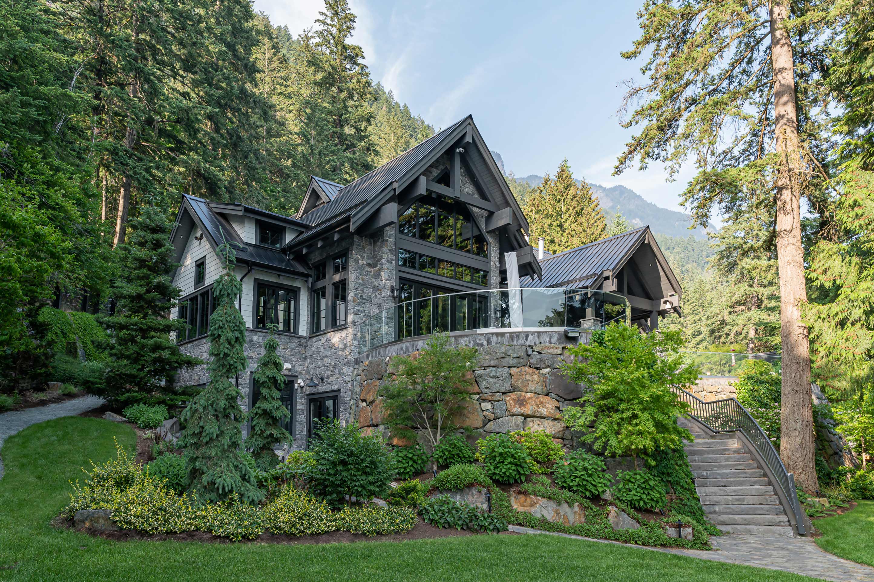 Front view of large lake house with beautiful gardens.