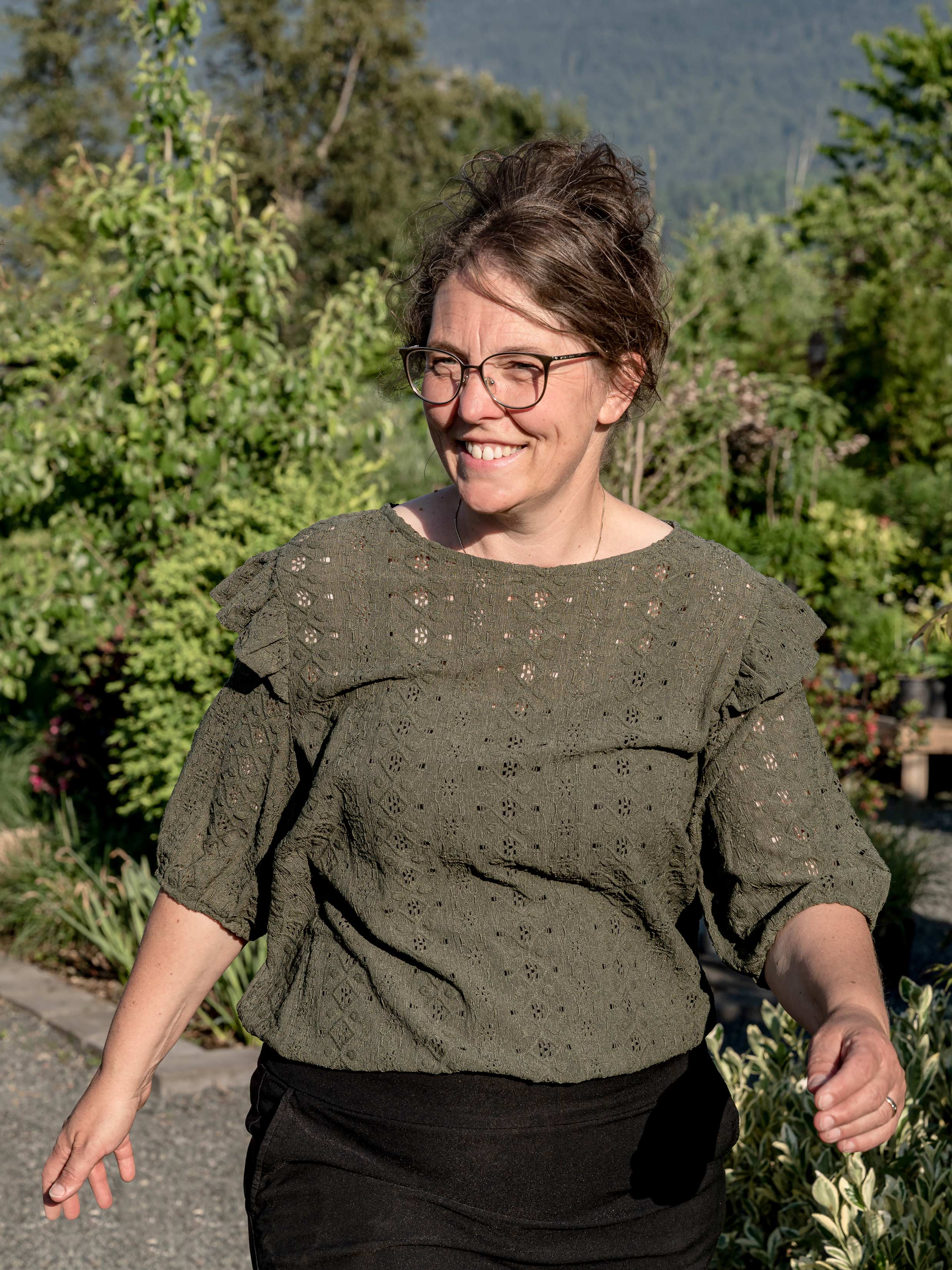 Tuene Marie, walks through the garden with a brilliant smile.