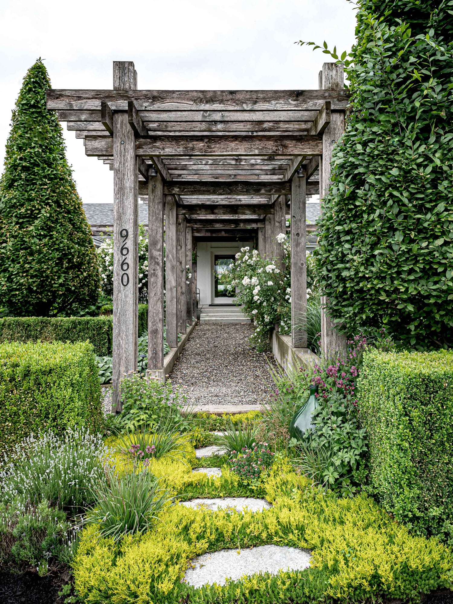  Pelly Road home pergola leads to front door with foliage on each side. 