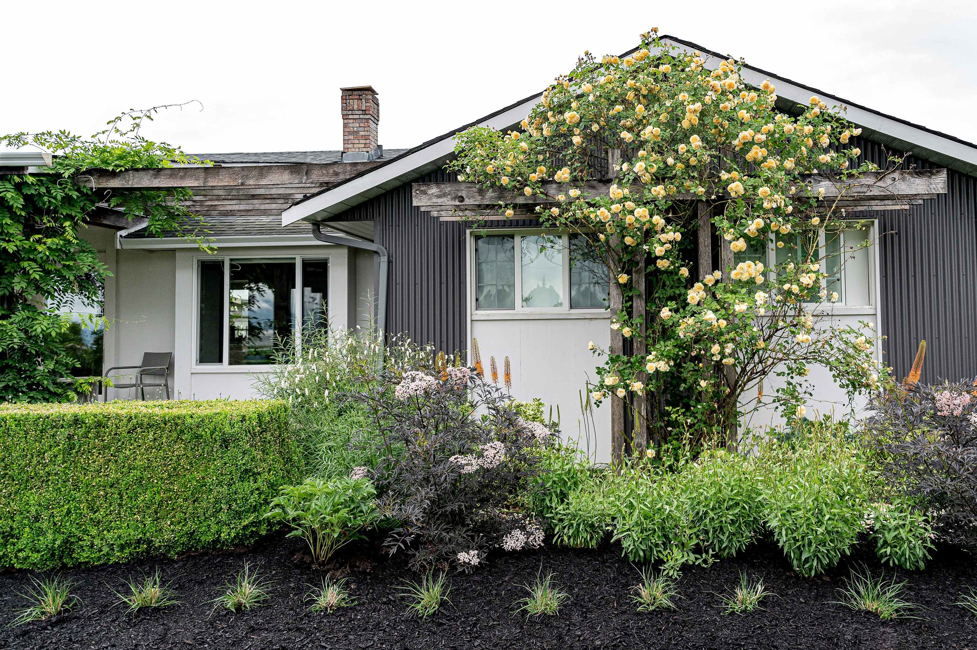 Front view of Pelly road home with yellow roses. 