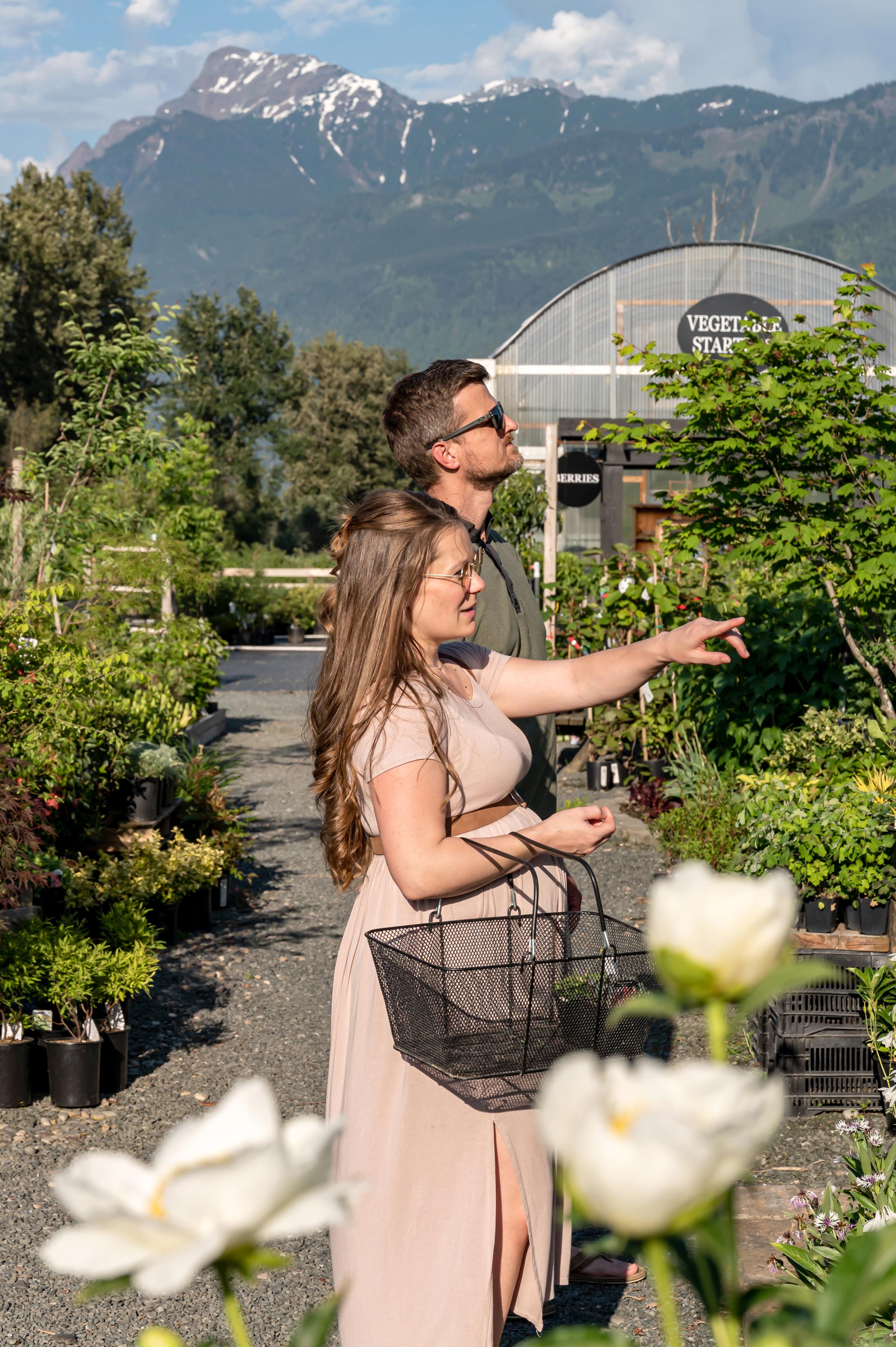 Beautiful woman and her husband shop the garden centre. 