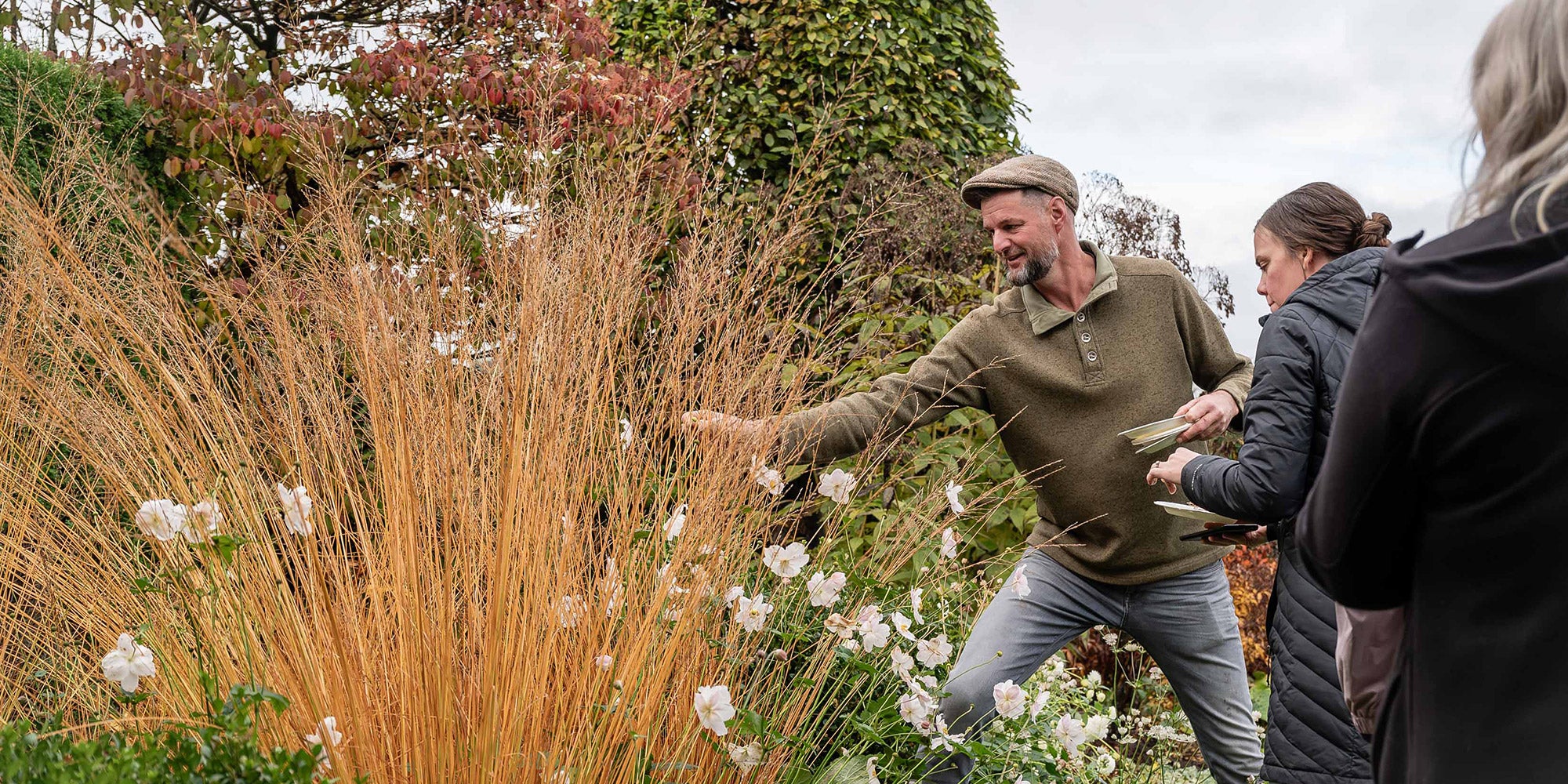 Jack showing student seed pods in the garden. 